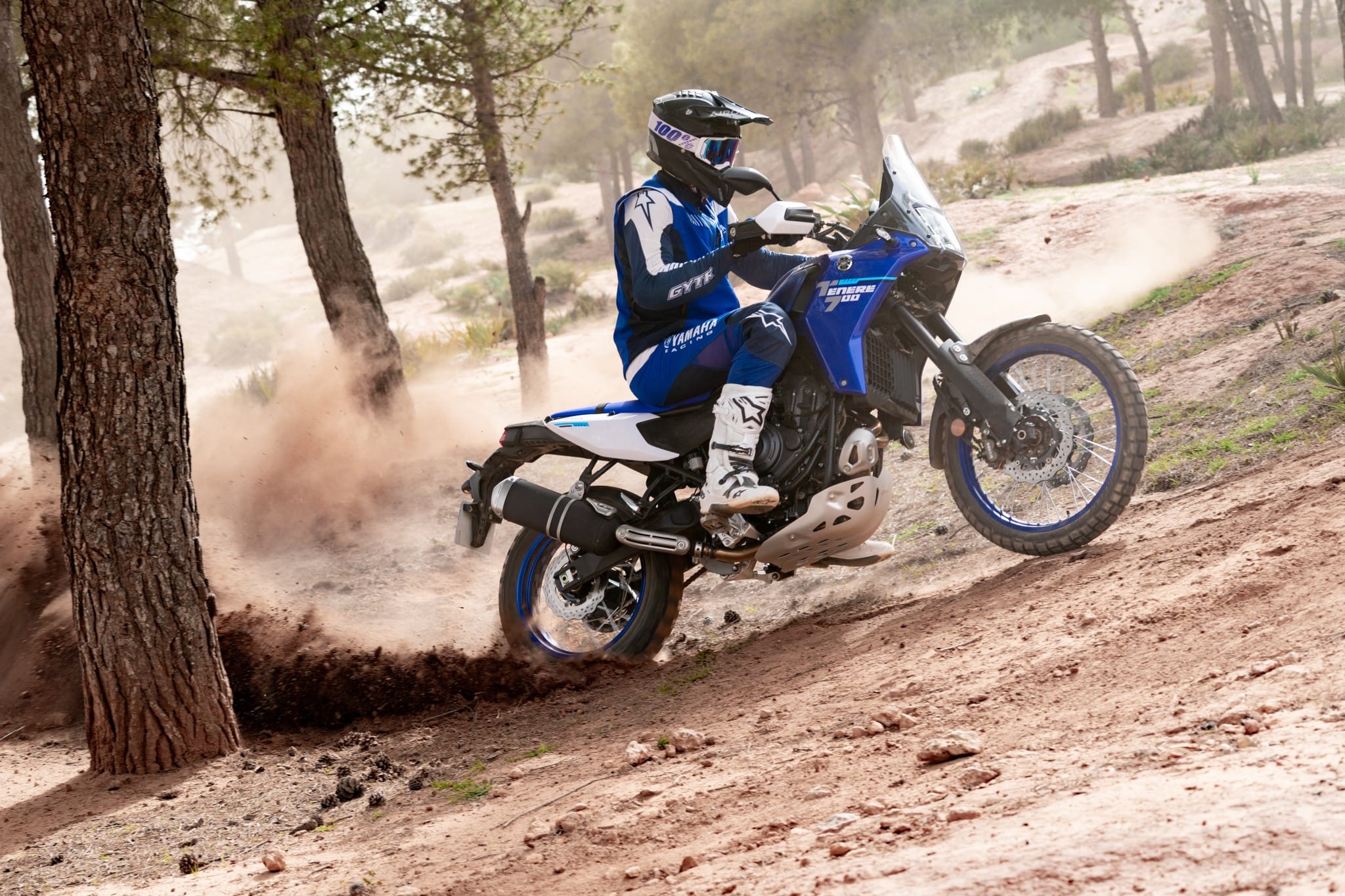 Yamaha Ténéré 700 werpt zand op tussen de bomen